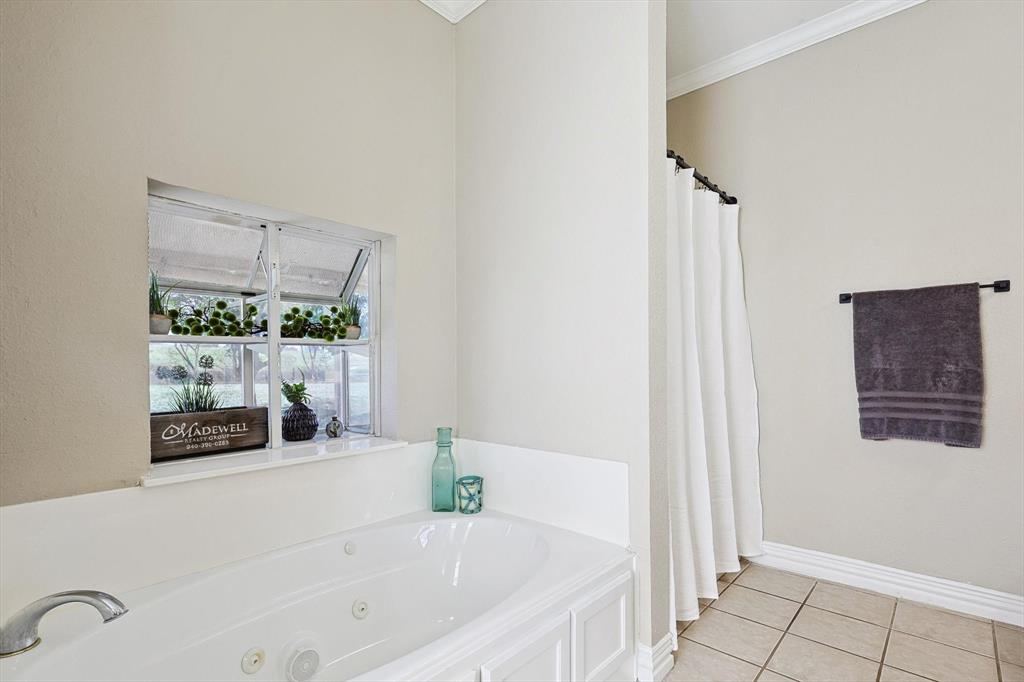 3289 Mitchell Road Krum, TX 76249 - Photo 16 of 40 a bath tub sitting next to a window