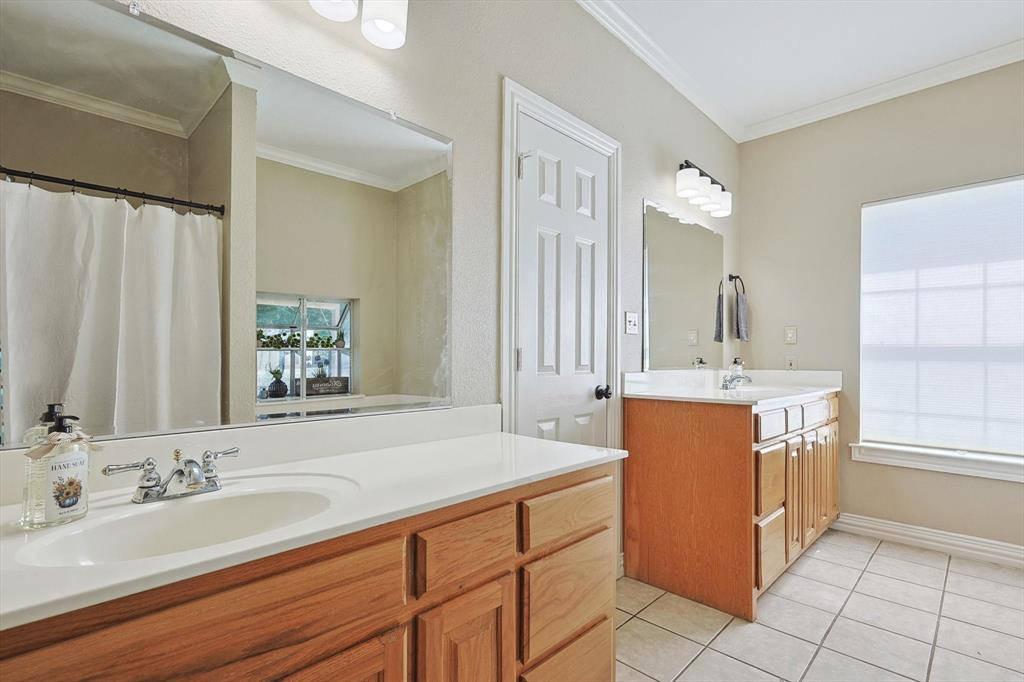 3289 Mitchell Road Krum, TX 76249 - Photo 17 of 40 a bathroom with a sink double vanity and a mirror