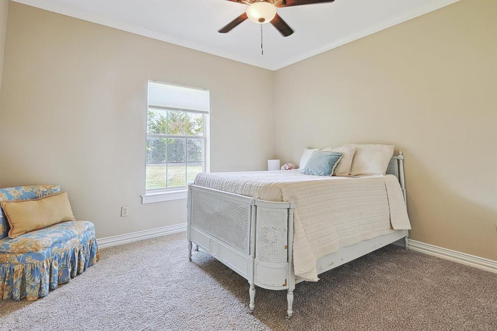 3289 Mitchell Road Krum, TX 76249 - Photo 20 of 40 a room with a bed and a window
