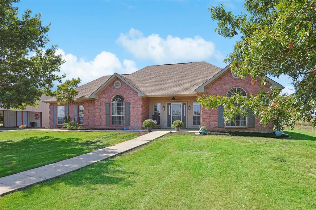 3289 Mitchell Road Krum, TX 76249 - Photo 2 of 40 a house view with a garden space