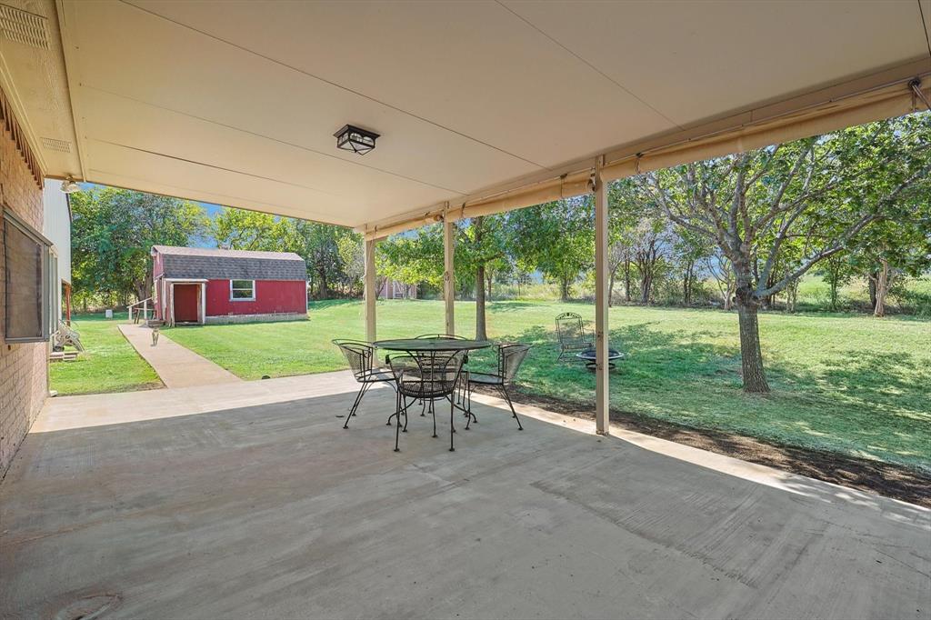 3289 Mitchell Road Krum, TX 76249 - Photo 22 of 40 a view of a house with porch and a yard