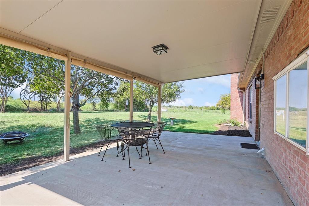 3289 Mitchell Road Krum, TX 76249 - Photo 23 of 40 a view of a porch with furniture and garden