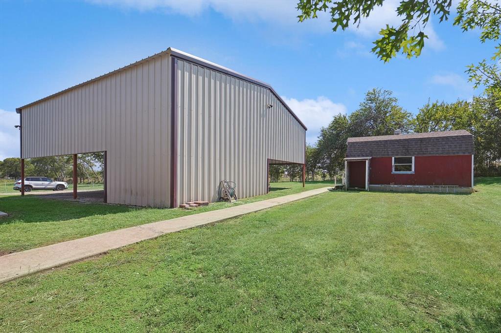 3289 Mitchell Road Krum, TX 76249 - Photo 24 of 40 a front view of a house with a garden
