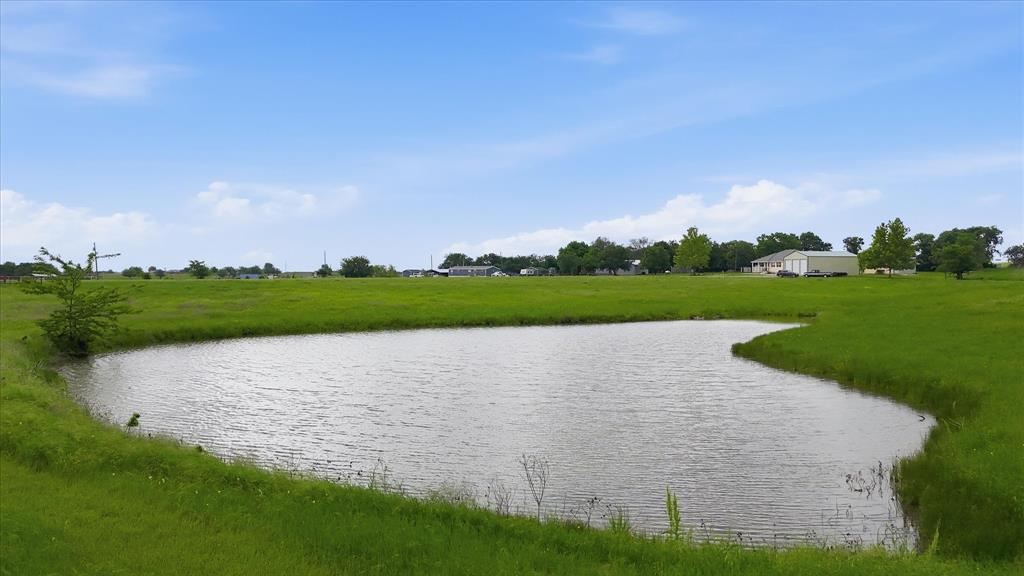 3289 Mitchell Road Krum, TX 76249 - Photo 35 of 40 a view of a lake and a yard