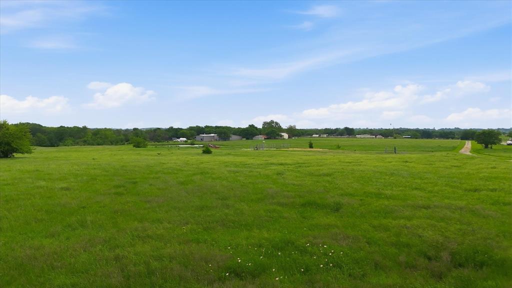 3289 Mitchell Road Krum, TX 76249 - Photo 36 of 40 a view of a green field with clear sky