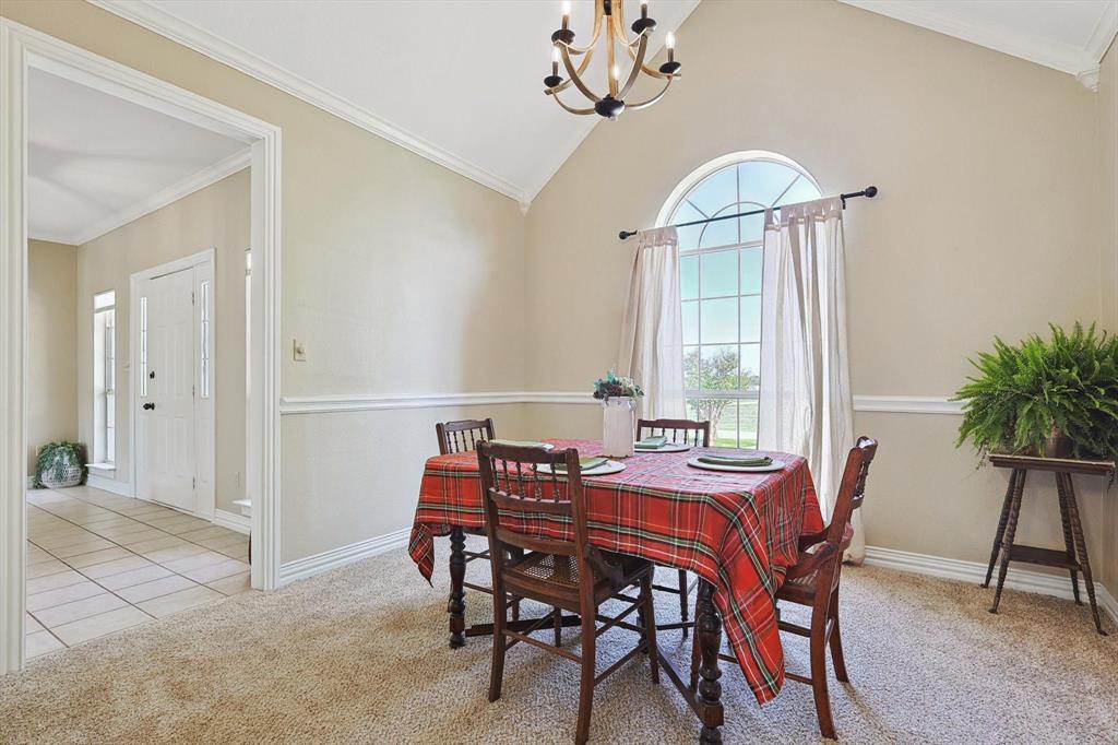 3289 Mitchell Road Krum, TX 76249 - Photo 9 of 40 a view of a dining room with furniture and chandelier