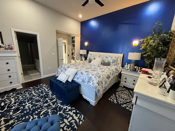 a bedroom with a bed and a mirror