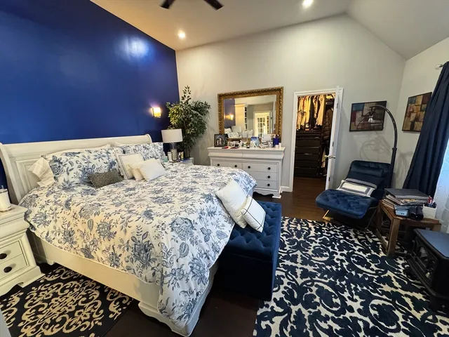 a bed sitting in a bedroom next to a window with tv