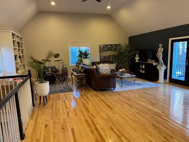 a living room with furniture and a wooden floor