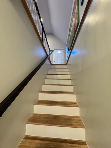 a bedroom with furniture and a flat screen tv