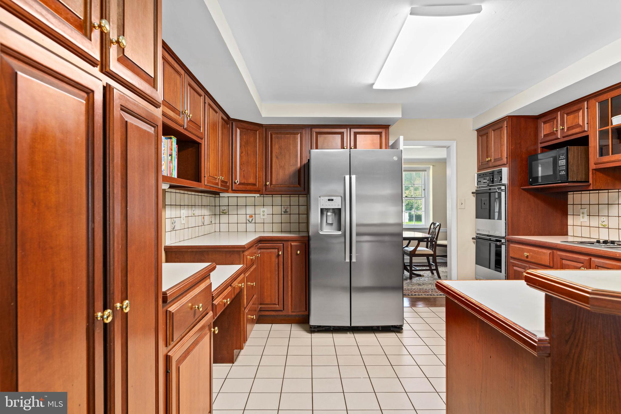 912 Centennial Road Penn Valley, PA 19072 - Photo 11 of 54 a kitchen with stainless steel appliances granite countertop a refrigerator and a stove