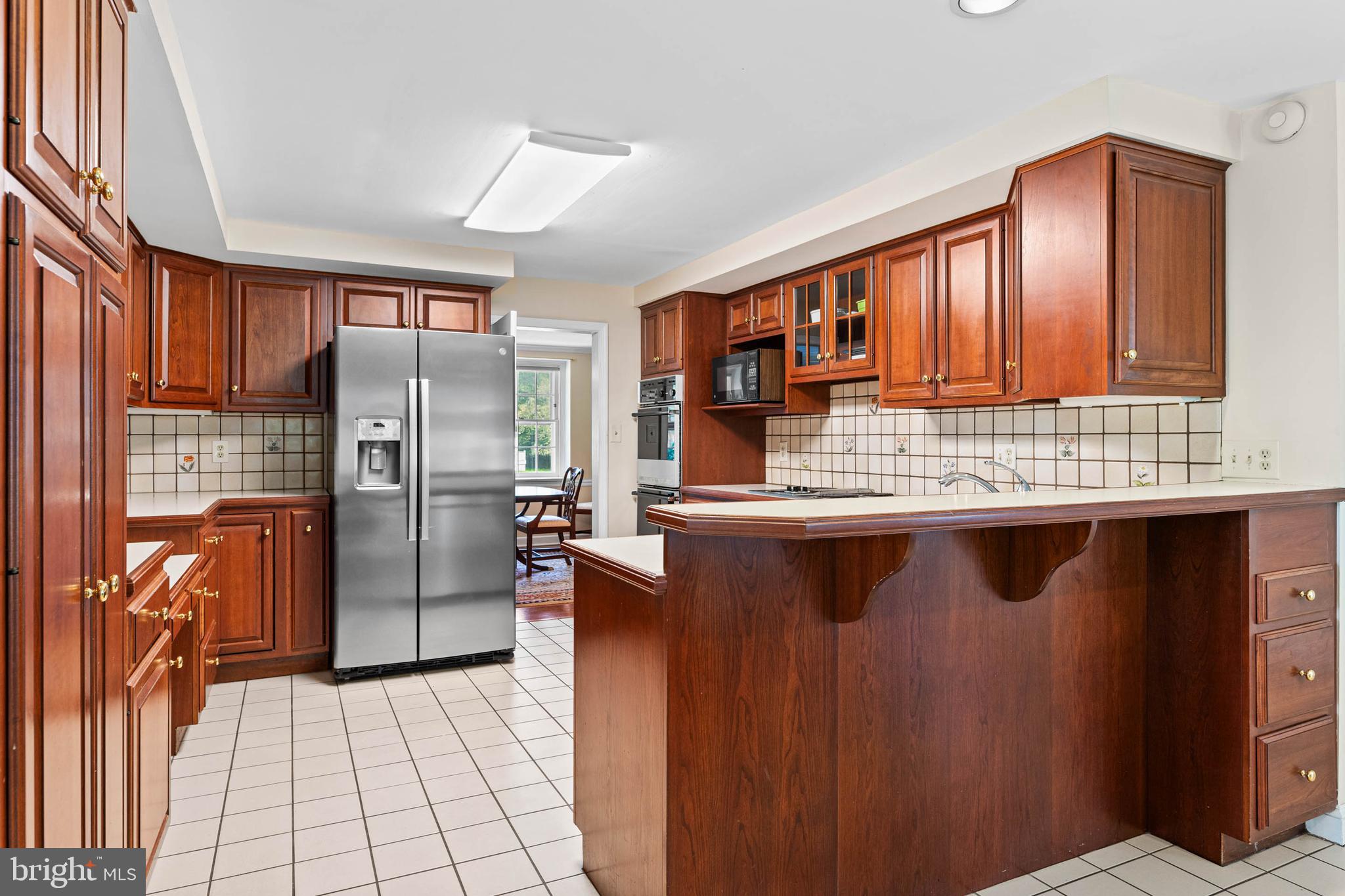 912 Centennial Road Penn Valley, PA 19072 - Photo 13 of 54 a kitchen with stainless steel appliances granite countertop a refrigerator and a stove