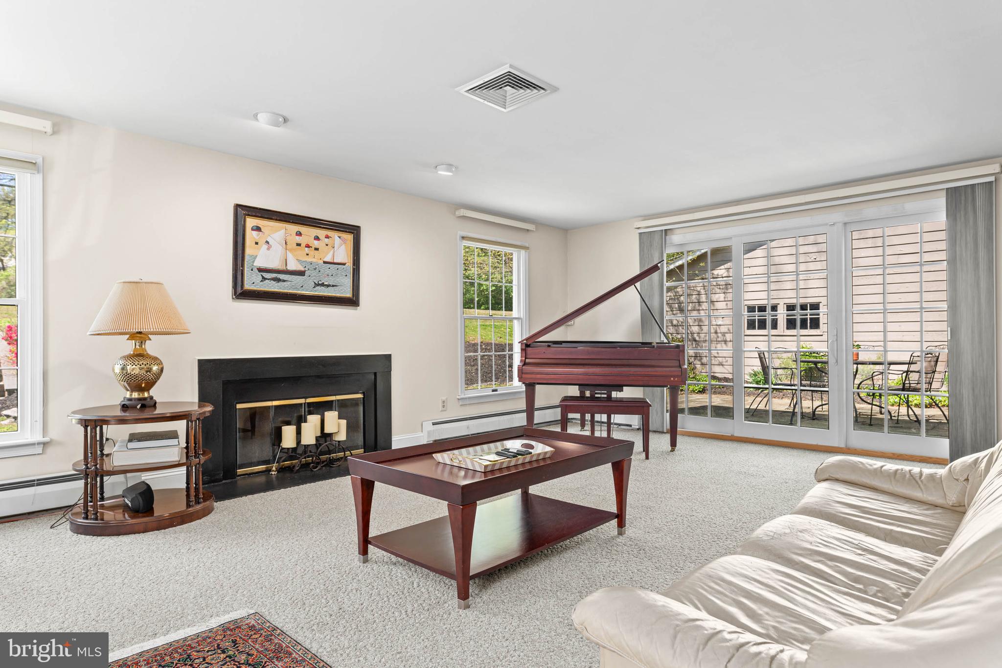 912 Centennial Road Penn Valley, PA 19072 - Photo 19 of 54 a living room with furniture and a fireplace