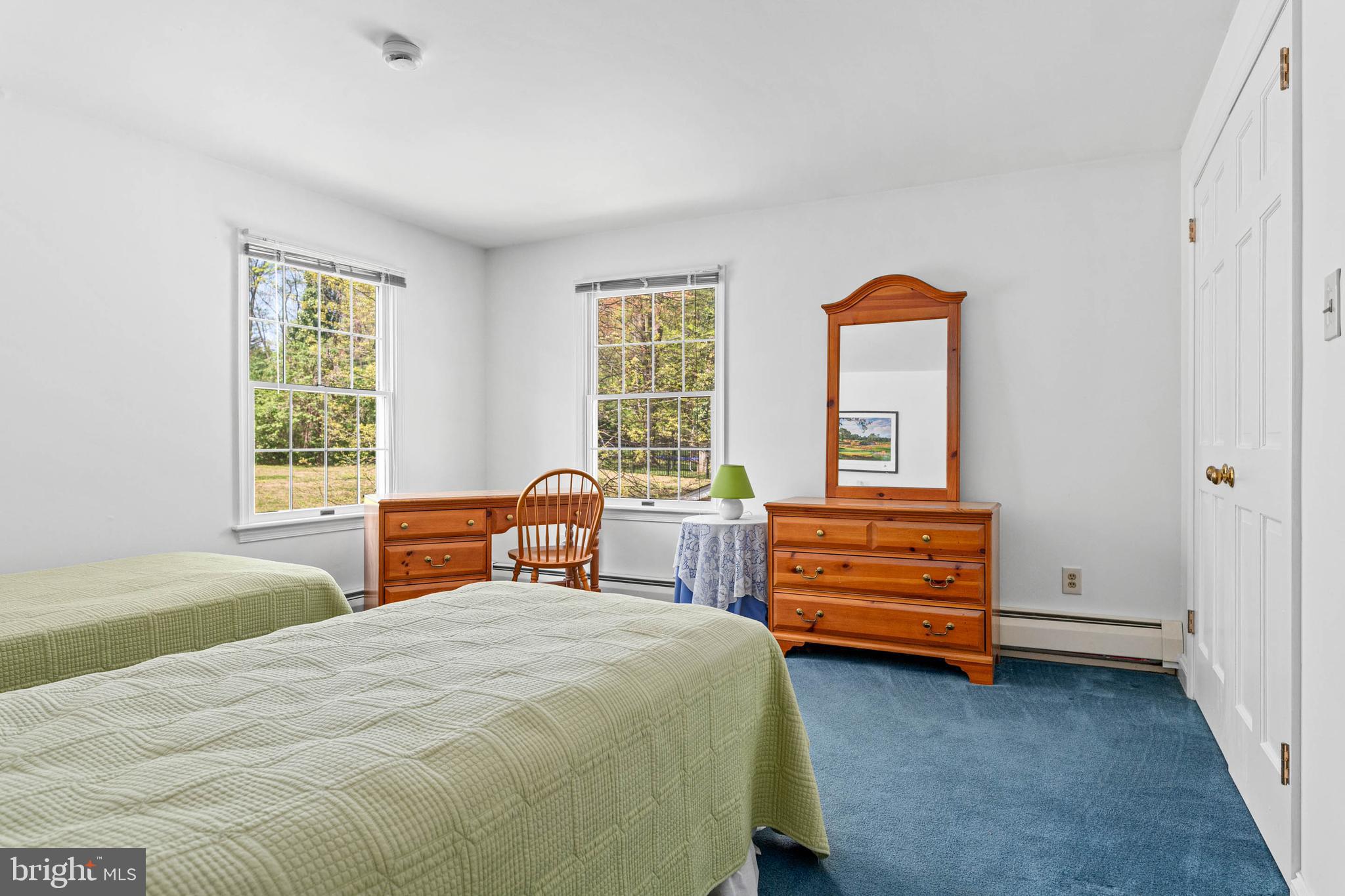 912 Centennial Road Penn Valley, PA 19072 - Photo 37 of 54 a bedroom with a bed and a dresser next to a window