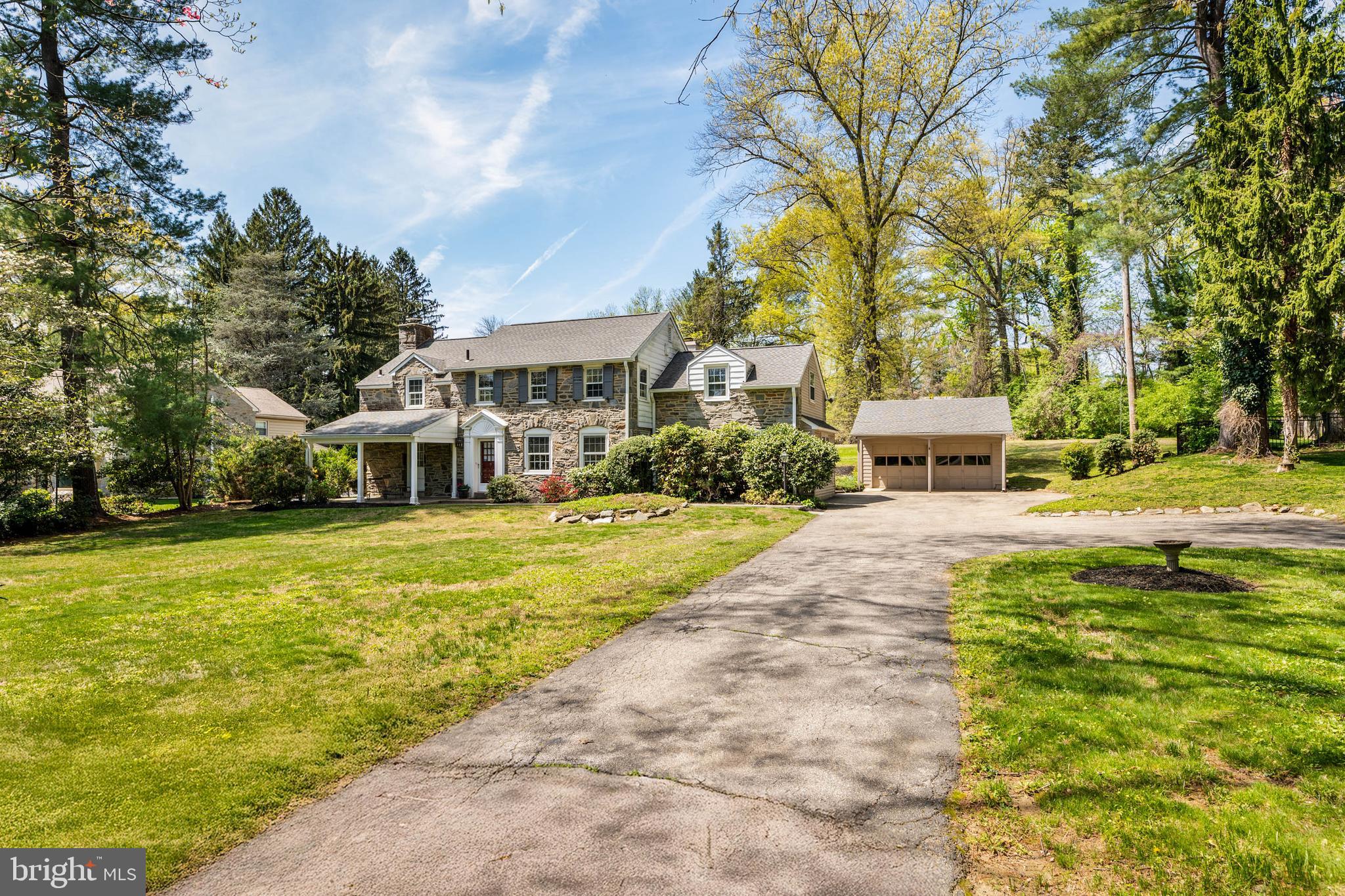 912 Centennial Road Penn Valley, PA 19072 - Photo 45 of 54 a front view of a building with garden and trees