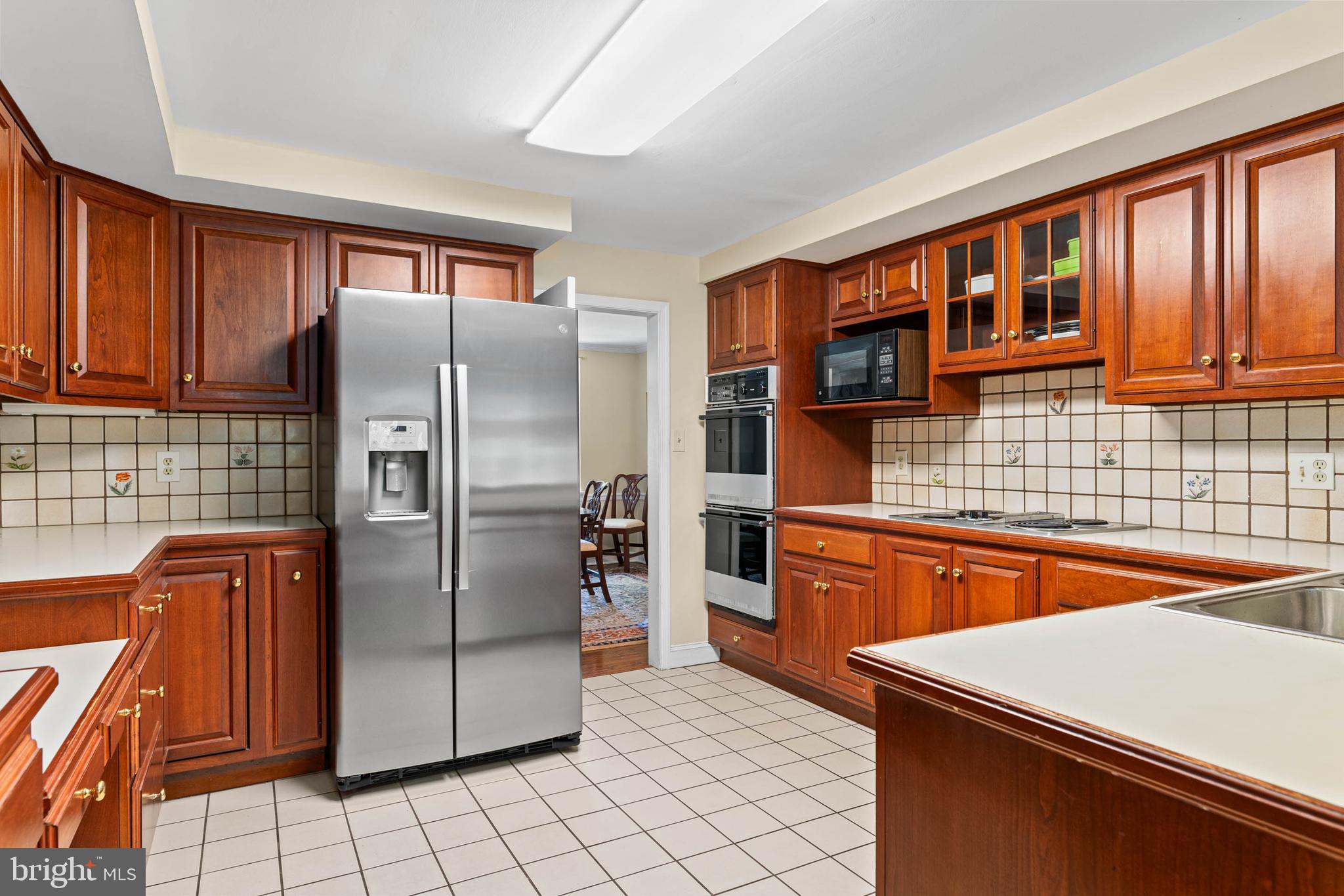 912 Centennial Road Penn Valley, PA 19072 - Photo 9 of 54 a kitchen with stainless steel appliances granite countertop a refrigerator and a sink