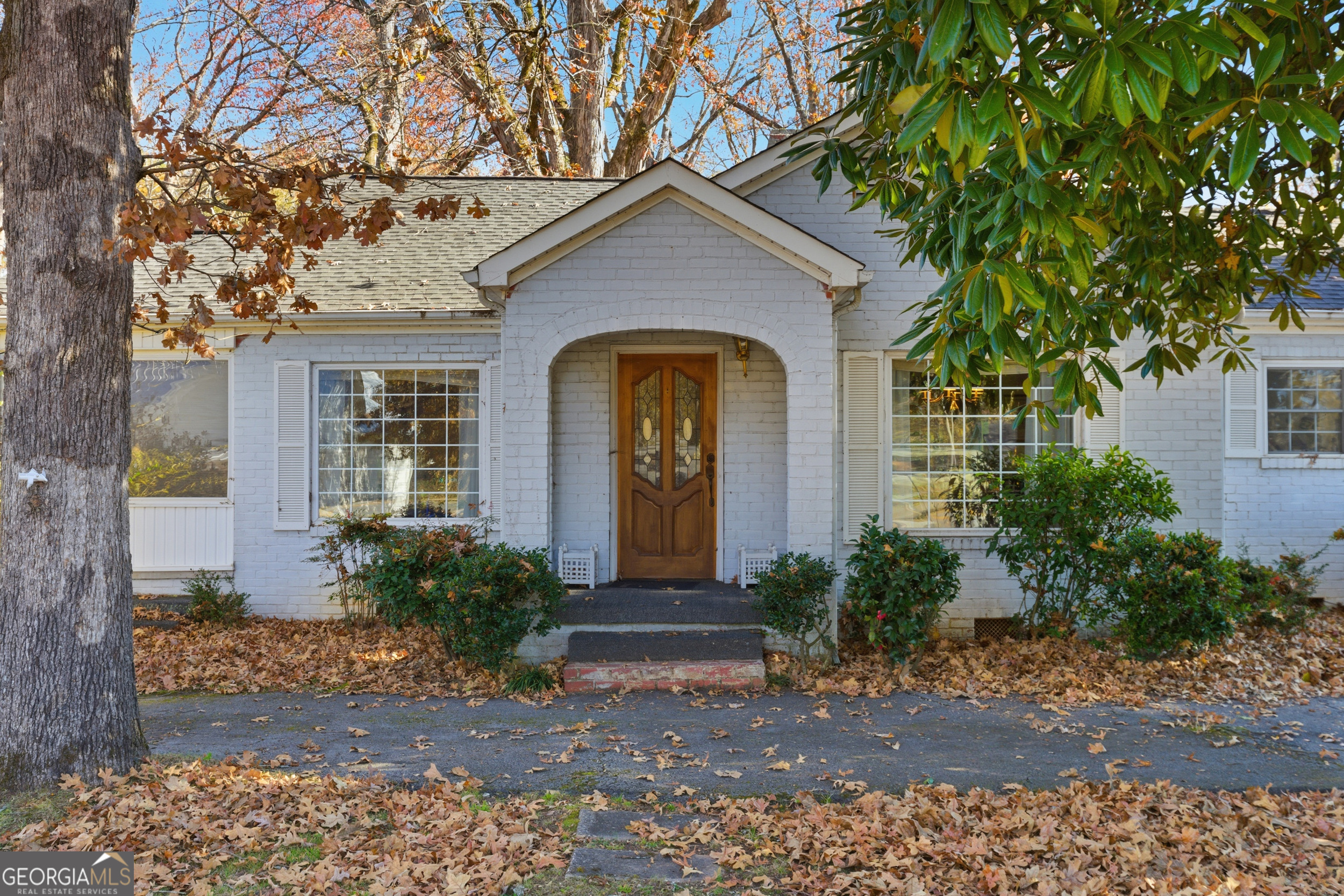 a front view of a house with garden