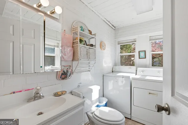 a bedroom with a bed and a flat tv screen on the dresser