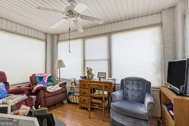 a view of a workspace with furniture and a window