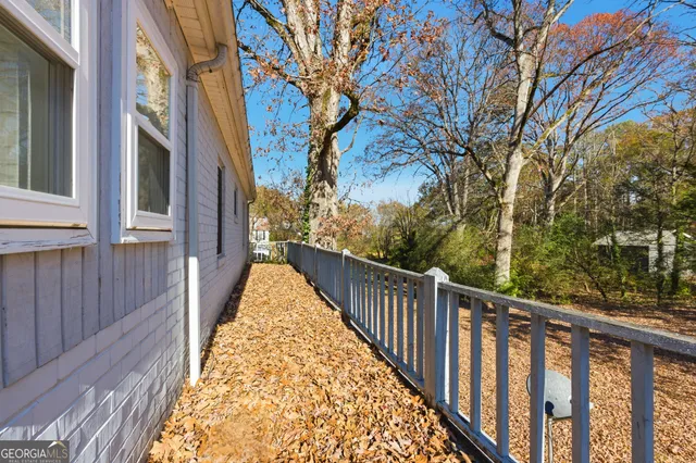a view of a house with a yard covered in snow