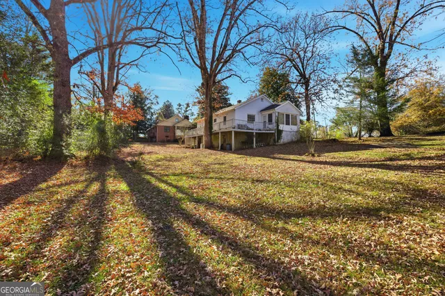 a front view of a house with a yard and trees
