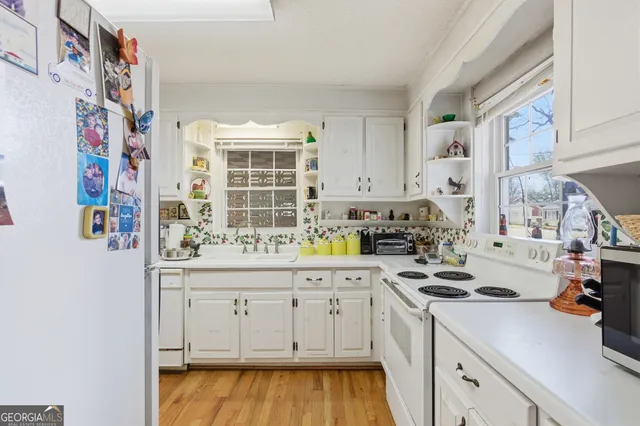 a kitchen with cabinets and window