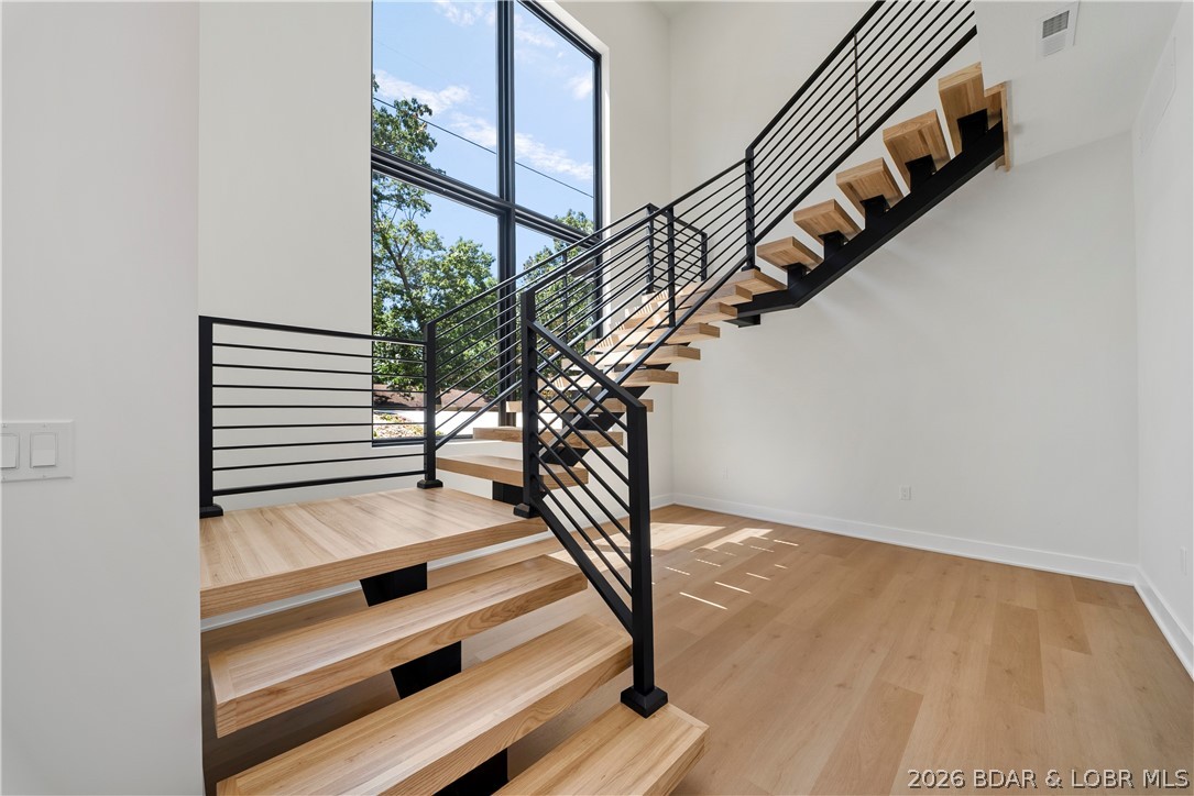 222 Red Bud Road Lake Ozark, MO 65049 - Photo 40 of 64 Stunning floating staircase showcasing modern arch