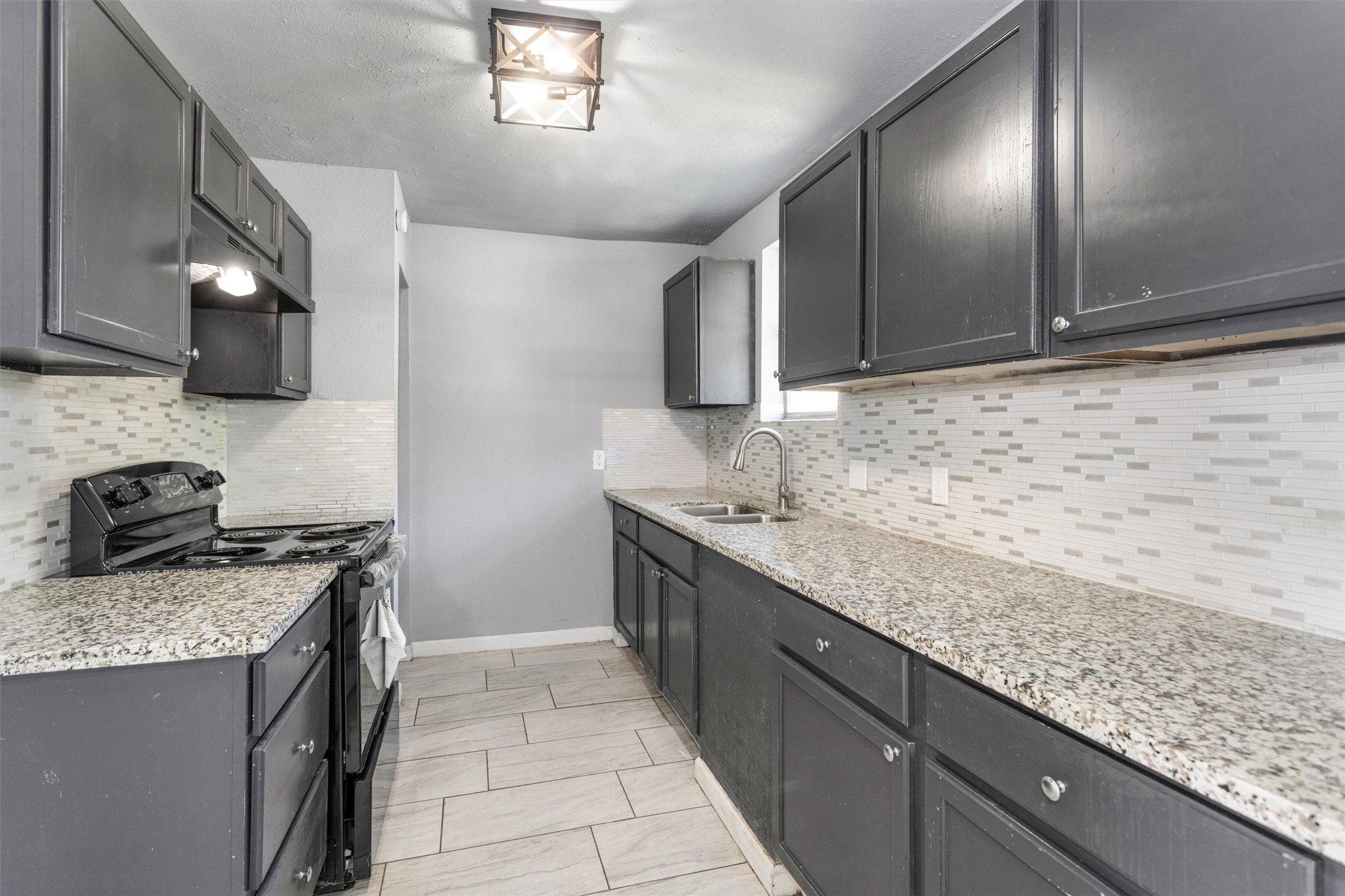 15225 Woodforest Boulevard Channelview, TX 77530 - Photo 14 of 29 a kitchen with stainless steel appliances granite countertop a sink stove and cabinets