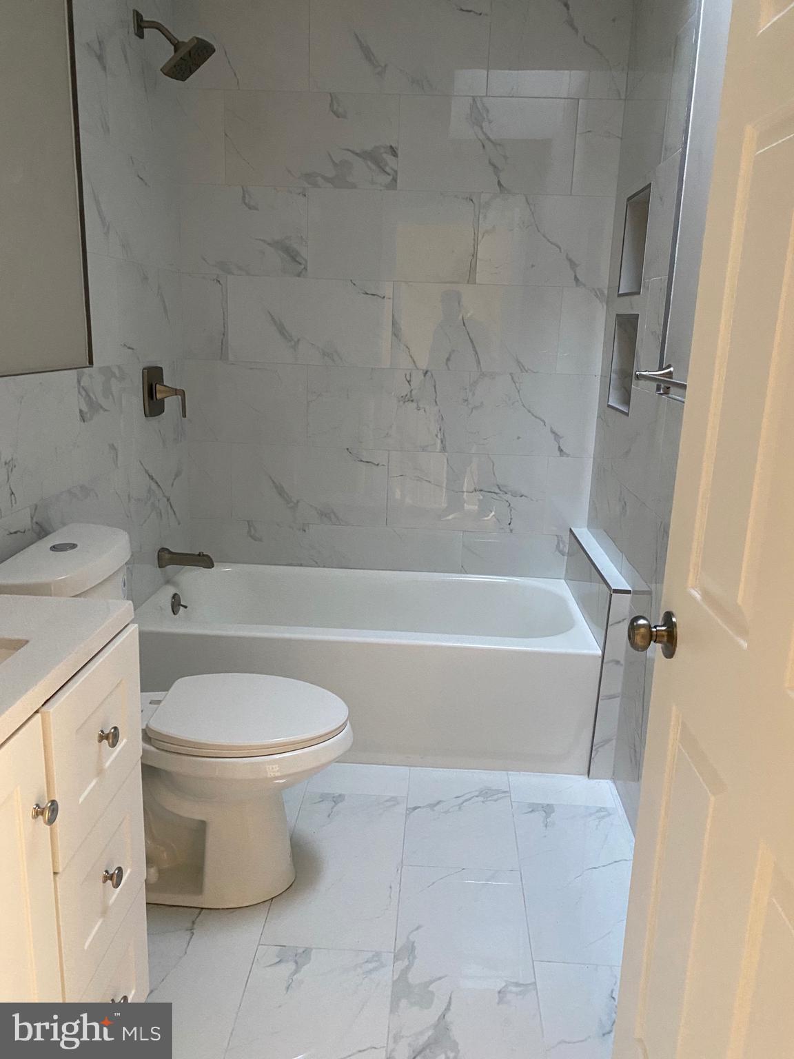 6445 Garman Street Philadelphia, PA 19142 - Photo 24 of 56 a bathroom with a toilet and a bath tub