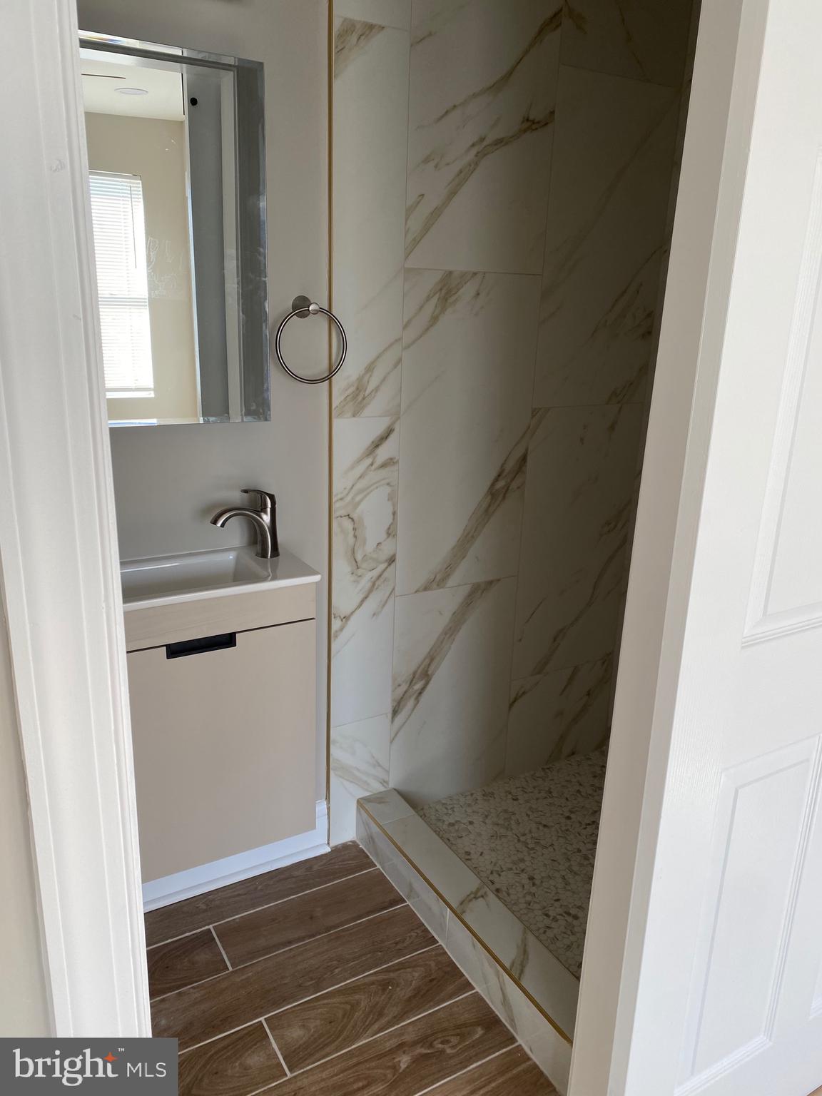 6445 Garman Street Philadelphia, PA 19142 - Photo 25 of 56 a bathroom with a sink and mirror