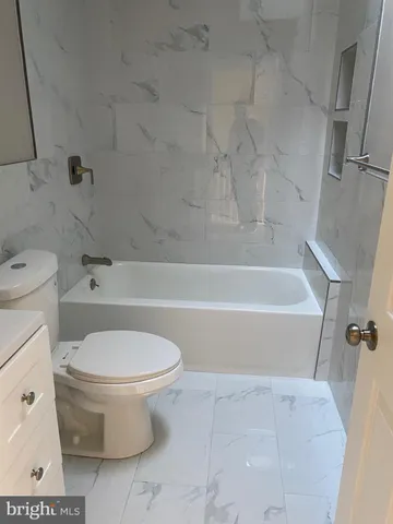 a bathroom with a sink a toilet and a bathtub