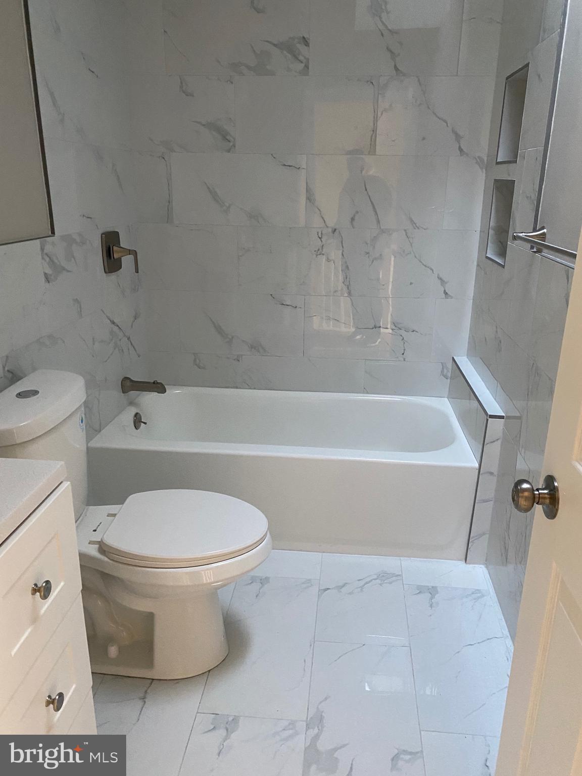 6445 Garman Street Philadelphia, PA 19142 - Photo 26 of 56 a bathroom with a toilet and a bath tub