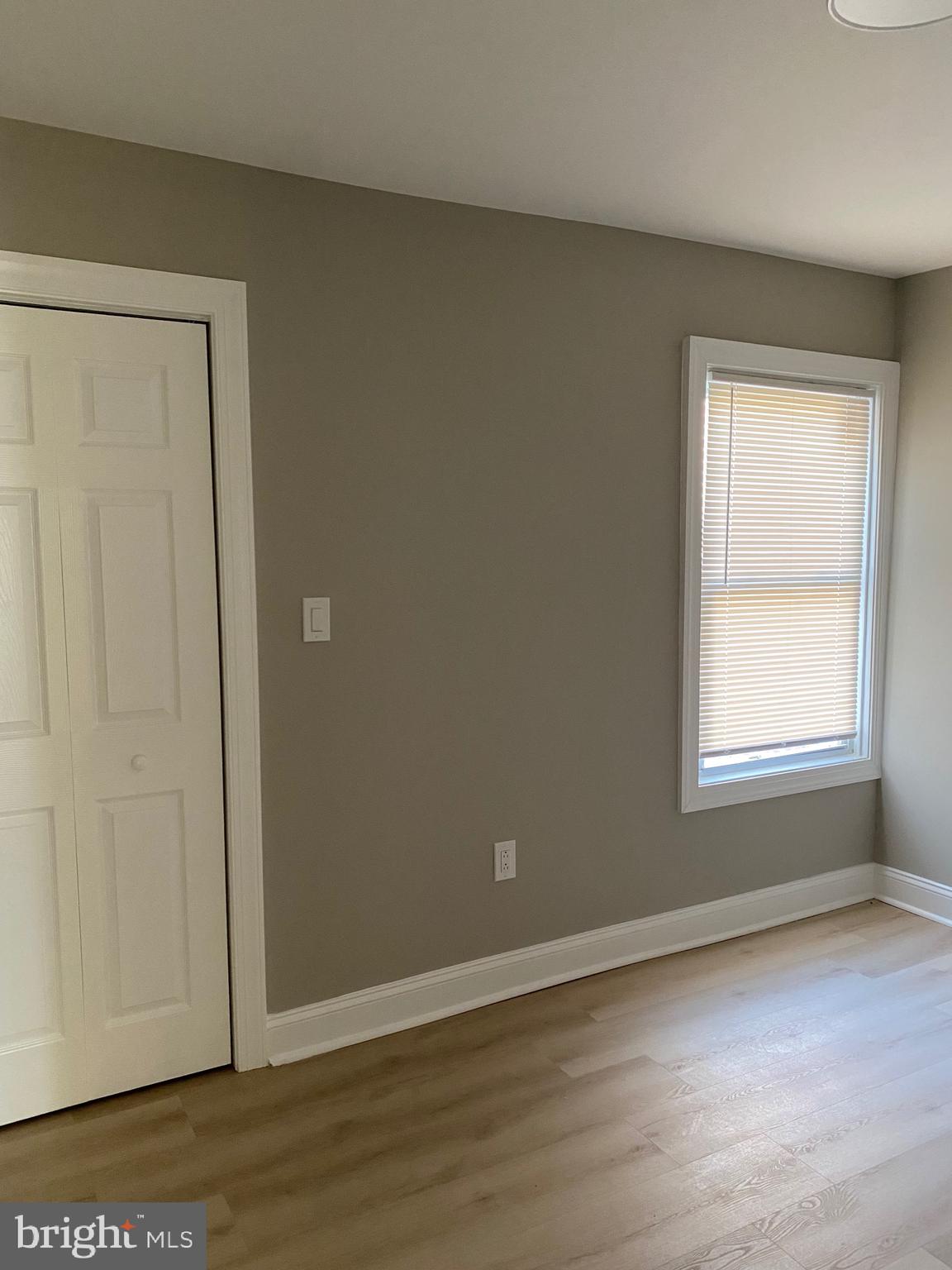 6445 Garman Street Philadelphia, PA 19142 - Photo 31 of 56 an empty room with wooden floor and windows