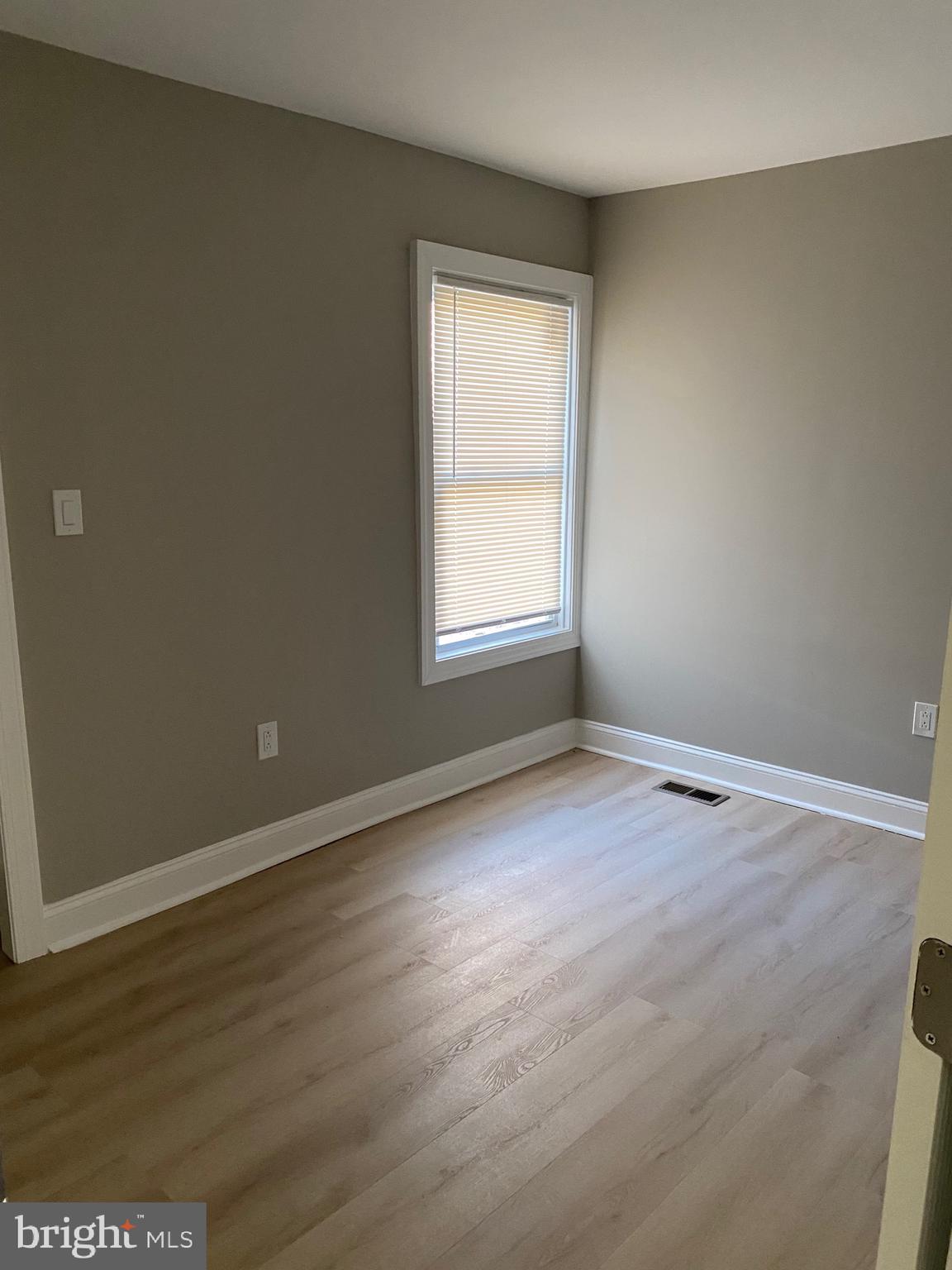 6445 Garman Street Philadelphia, PA 19142 - Photo 33 of 56 an empty room with wooden floor and windows