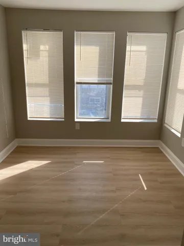 an empty room with wooden floor
