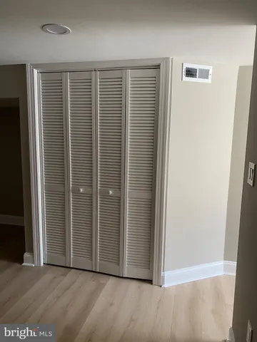 a room with a wooden floor and a window