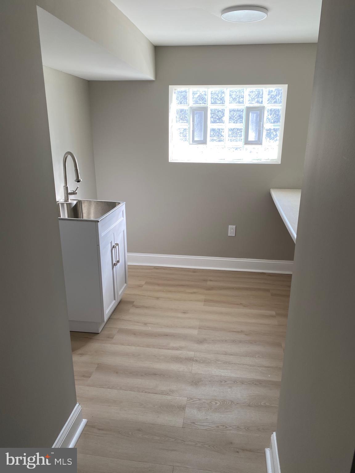 6445 Garman Street Philadelphia, PA 19142 - Photo 47 of 56 a view of an empty room with wooden floor and a window