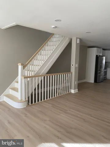 a kitchen with stainless steel appliances granite countertop a stove a sink and white cabinets