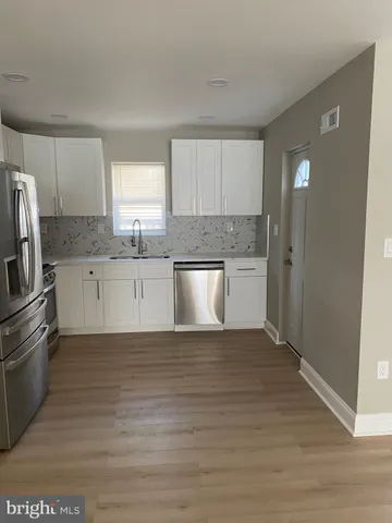 a white refrigerator freezer sitting in a kitchen