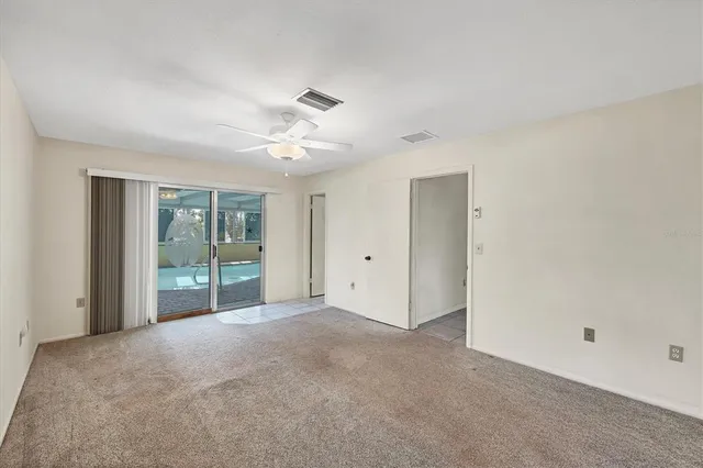 a view of an empty room with glass door