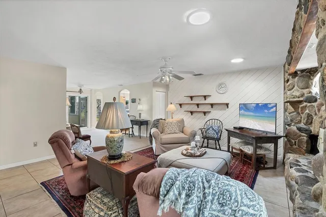 a living room with furniture fireplace and a flat screen tv