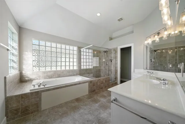 a spacious bathroom with sink shower and bathtub