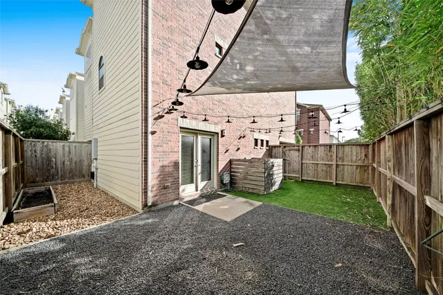 a view of a backyard with wooden fence