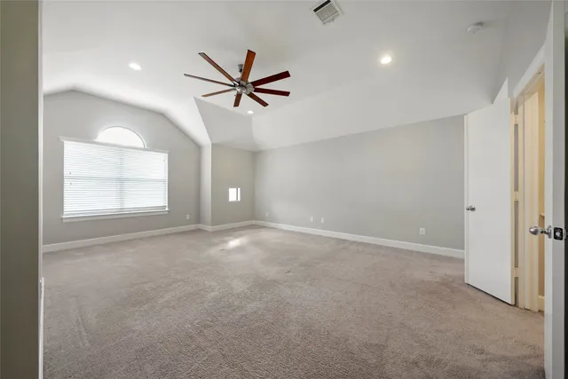 a view of a livingroom with a ceiling fan and window