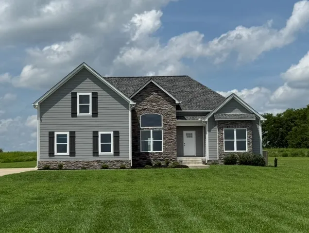 a front view of a house with a garden