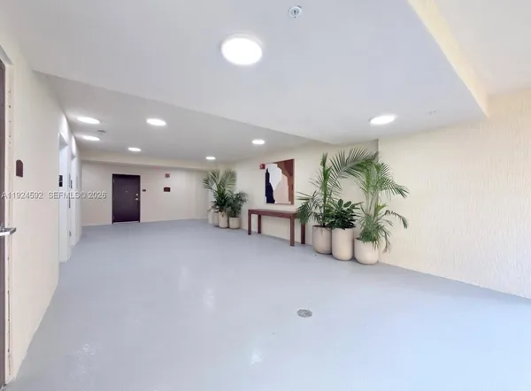 a view of a livingroom with a table and chairs