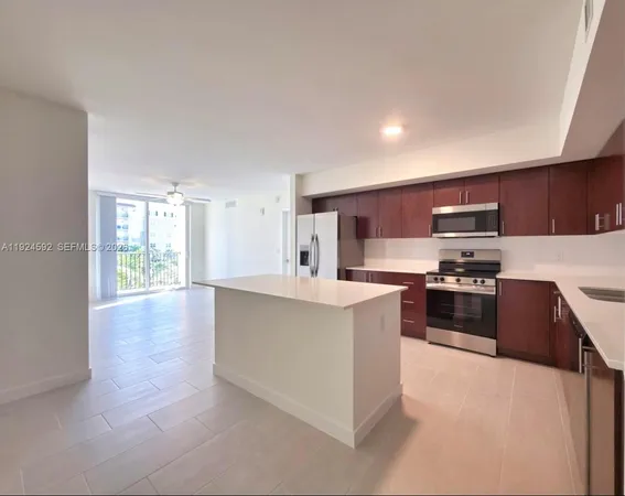 a kitchen with stainless steel appliances a stove a sink a microwave and cabinets