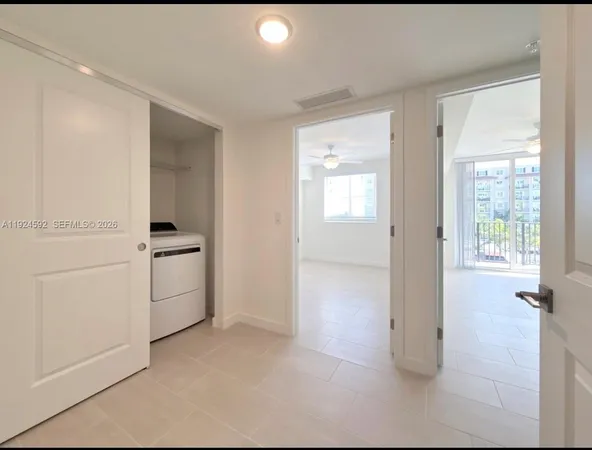 a view of a kitchen with white cabinets and white appliances