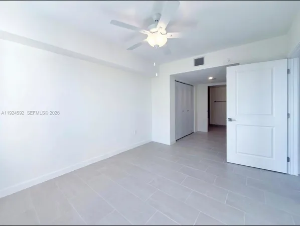 an empty room with a ceiling fan and a ceiling fan