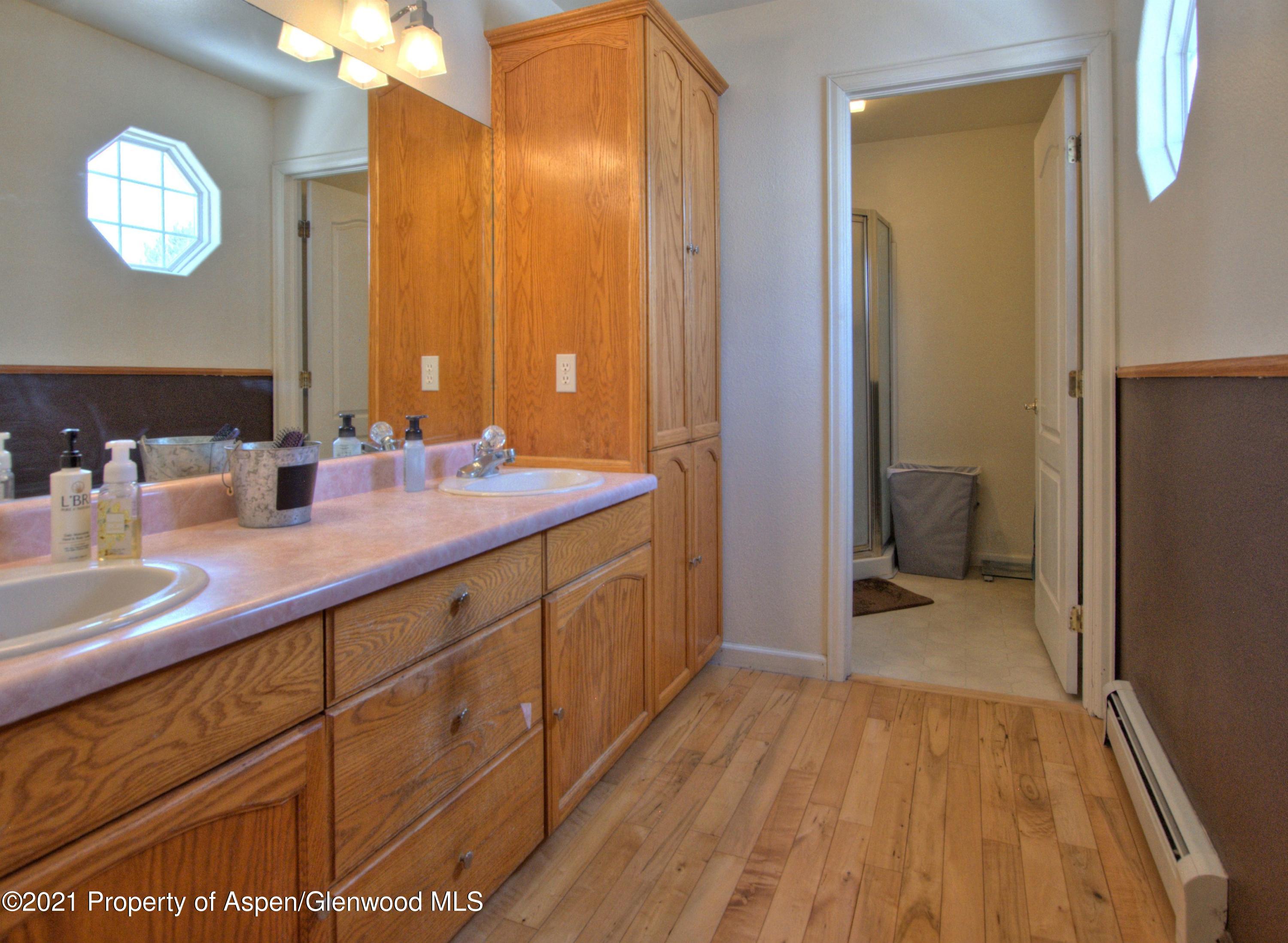 1554 East 12th Street Rifle, CO 81650 - Photo 17 of 31 a spacious bathroom with a sink and a mirror